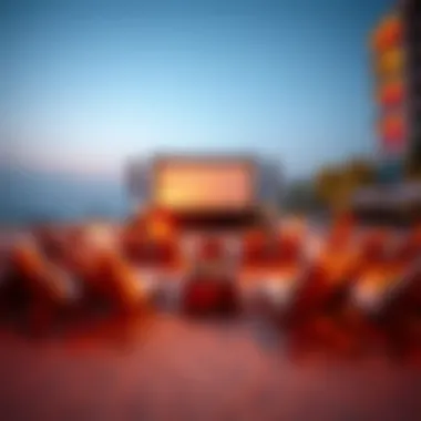 An inviting setup of lounge chairs in front of the cinema screen by the beach